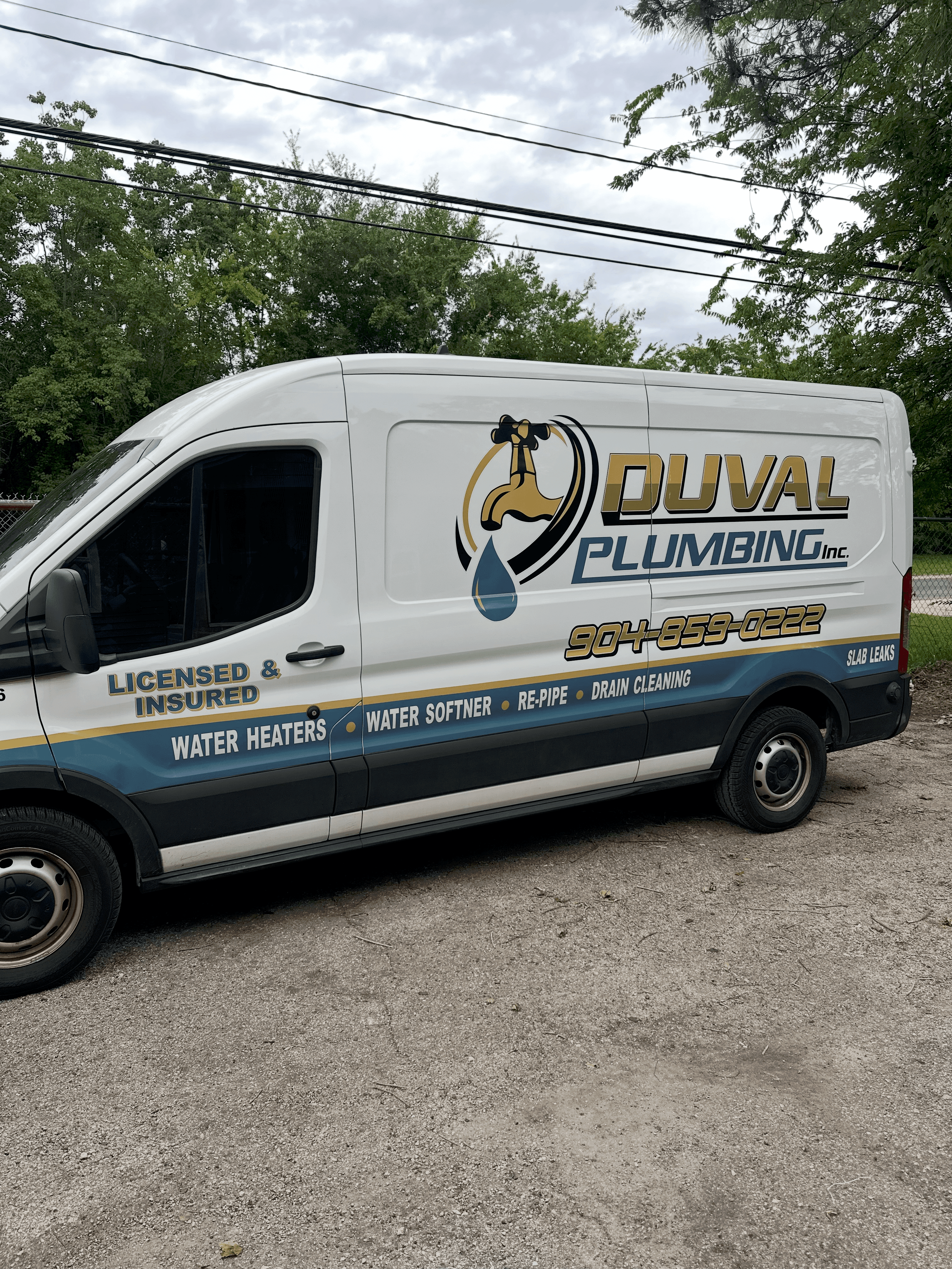 White Duval Plumbing Inc. service van with company logo, phone number, and listed plumbing services.